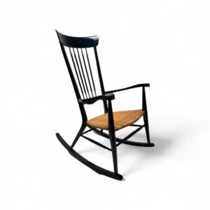 Sleek Spindle Rocker with handwoven cane seat and black frame