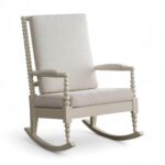 Classic spindle-style wooden rocking chair with fabric upholstery