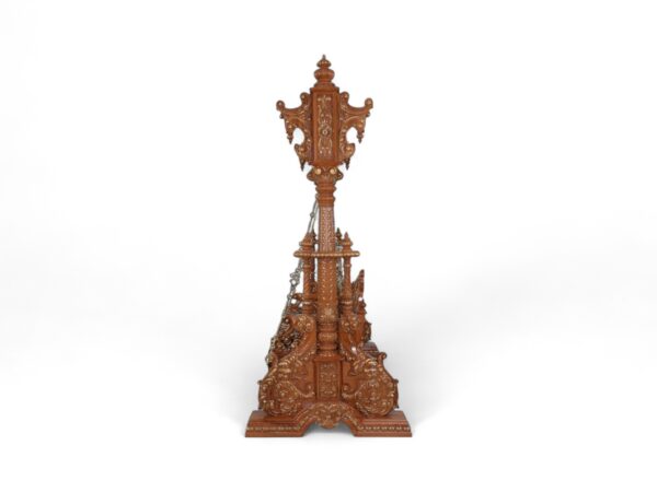 Luxurious teak wood swing with traditional carvings and regal presence