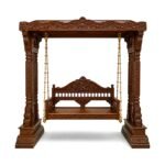handcrafted wooden swing with dark finish and carved pillars