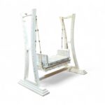 Side angle of Majestic White Carved Swing showing curved supports and ornate detailing
