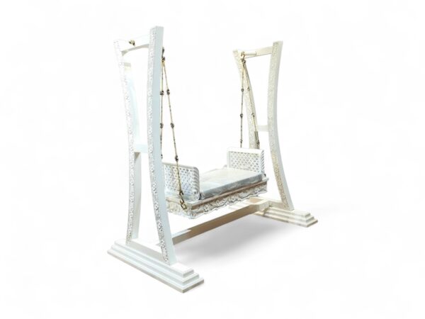 Side angle of Majestic White Carved Swing showing curved supports and ornate detailing