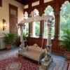 Heritage Peacock Swing with carved wooden pillars and cushioned seat
