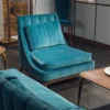 Modern teal velvet lounge chair with sculptural form