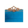 Statement sapphire-blue bed with ornate golden accents