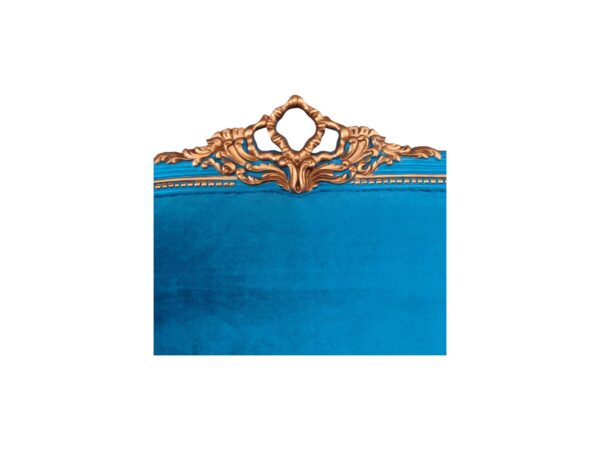 Statement sapphire-blue bed with ornate golden accents