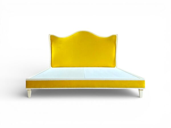 Soleil Curve Bed in vibrant yellow velvet with arched headboard