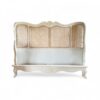 Luxury bed with antique white finish and hand-woven cane panels