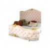 Luxury pink velvet bed featuring gold carvings and curved edges.