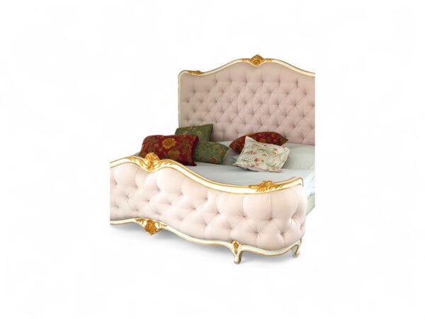 Luxury pink velvet bed featuring gold carvings and curved edges.