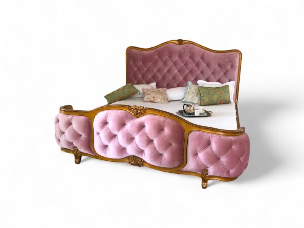 French romantic bed with tufted pink velvet and curved gold wood