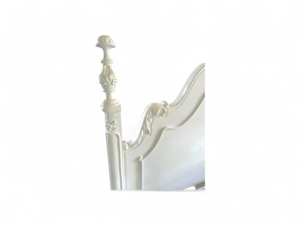 Romantic white French bed with classic carved details and soft finish
