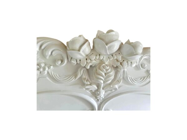 Vintage French bed with detailed headboard and elegant curves