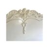 Antique-style French bed with soft white paint and carved detailing