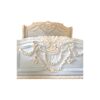 Pastel-colored carved wooden bed with detailed floral embellishments