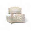 French-style carved bed in pastel tones with elegant neoclassical details