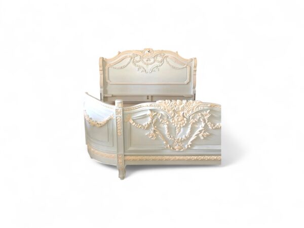French-style carved bed in pastel tones with elegant neoclassical details