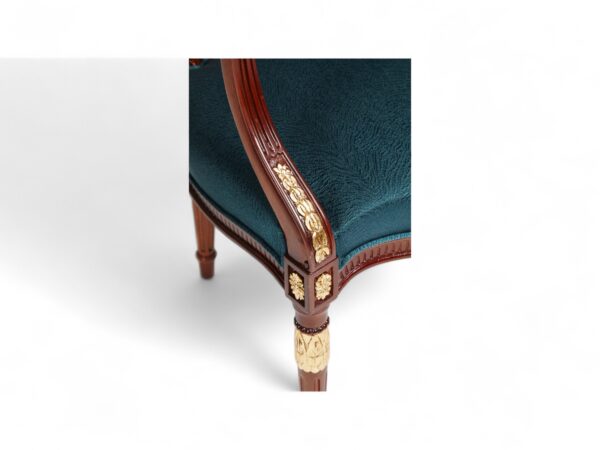 Louis-style accent chair with elegant gold detailing and padded arms
