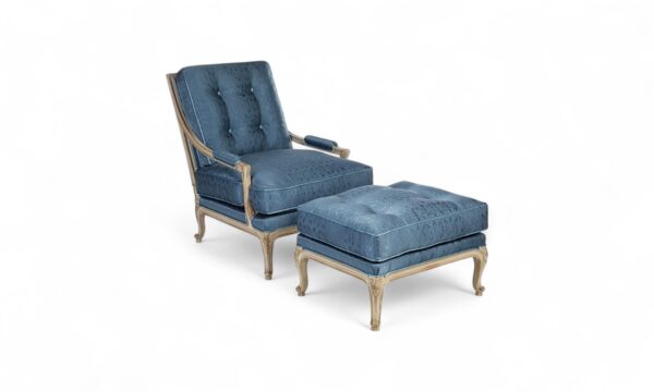 Blue velvet lounge chair with ottoman and carved wood frame