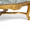 Elegant armchair with high back and golden detailing