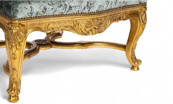 Elegant armchair with high back and golden detailing