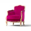 Luxurious fuchsia velvet armchair with intricate wood carving