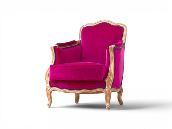 Luxurious fuchsia velvet armchair with intricate wood carving