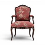 Ebony Splendour Armchair with intricate carvings and floral upholstery