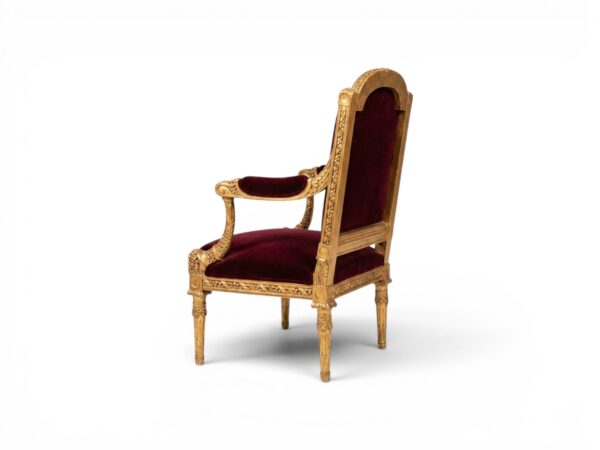 Luxury accent chair in rich red velvet and gold leaf detailing