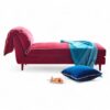 Elegant chaise lounge with gold base and cushioned seat