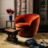 Contemporary burnt orange velvet chair with round silhouette