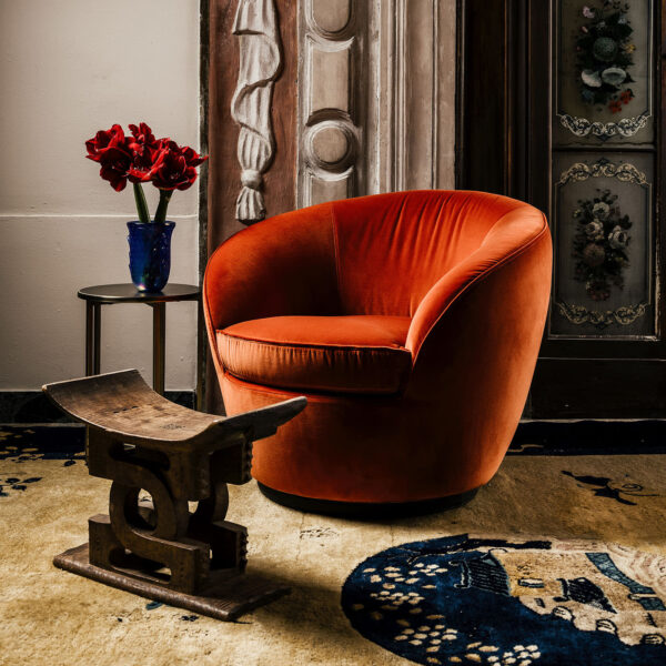 Contemporary burnt orange velvet chair with round silhouette