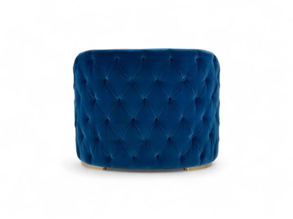 Luxurious blue velvet armchair with tufted backrest and gold legs