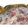 Elegant carved teak armchair with floral fabric upholstery