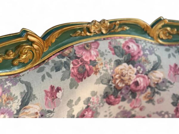 Elegant carved teak armchair with floral fabric upholstery
