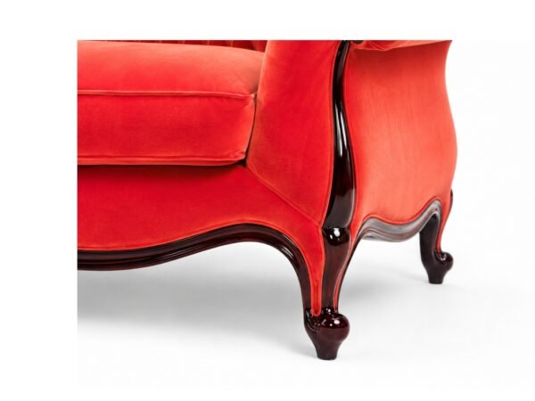 Luxurious red velvet chaise lounge with rolled arms
