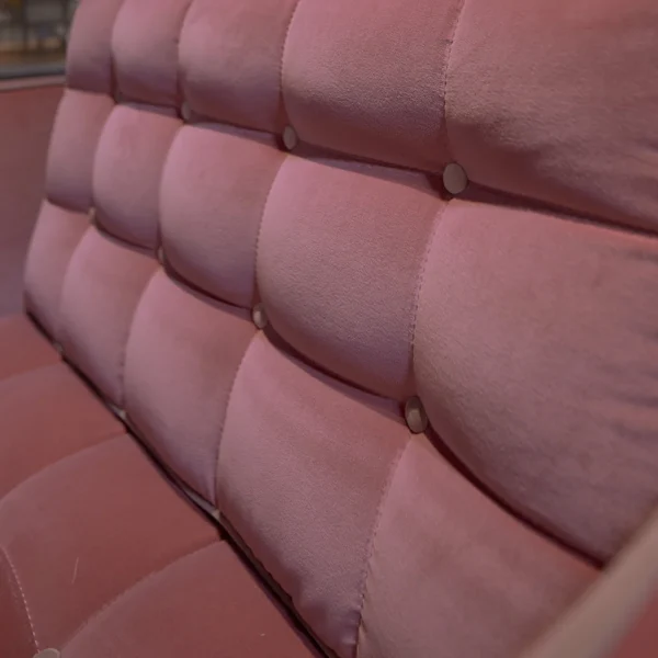 Soft blush velvet upholstered armchair with modern wooden frame