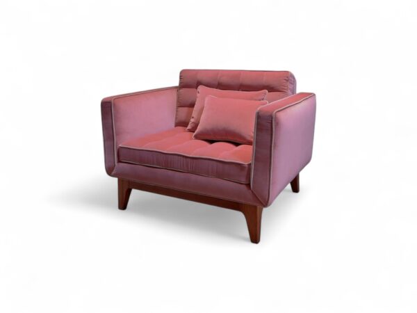 Elegant blush velvet armchair with plush cushioning and minimal design