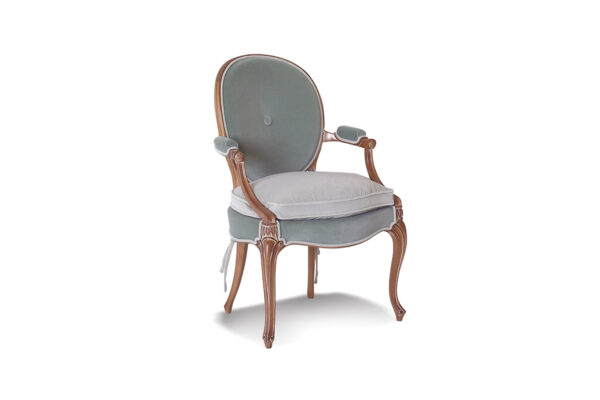 Bold velvet armchair in fuchsia and orange, perfect for stylish interiors.