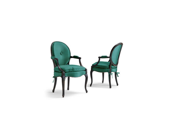 Elegant fuchsia velvet armchair with carved wooden frame