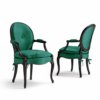 Elegant velvet armchair with carved wooden frame
