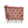Blush velvet armchair with tufted base and olive green detailing