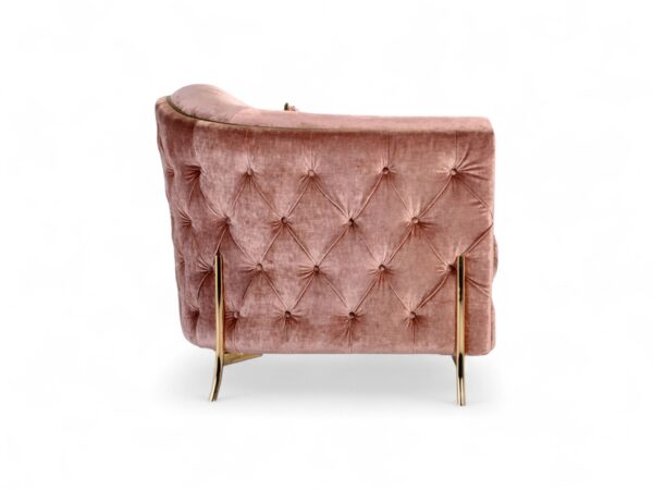 Blush velvet armchair with tufted base and olive green detailing