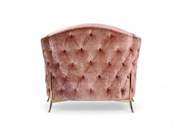 Modern blush armchair with accent cushion and sculptural design