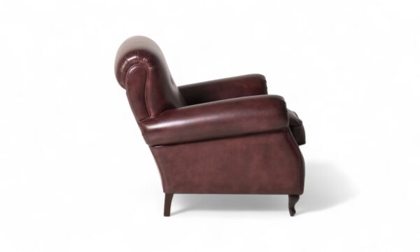 Classic leather club chair with tufted back and turned legs