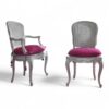 Vintage carved wood chair with cushioned seating and scroll arms