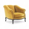 Mustard velvet armchair with dark carved wooden legs