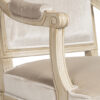 Classic upholstered armchair with heritage detailing and light finish