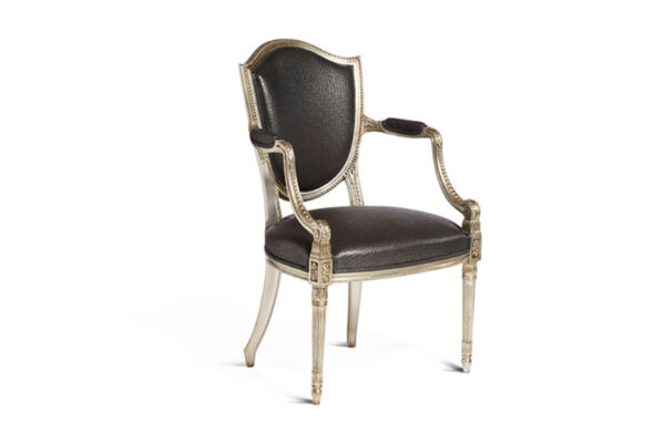 Luxury armchair featuring rich purple velvet and carved silver details