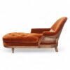 Side view of Opulent Orange Chaise Lounge showcasing its curved high backrest